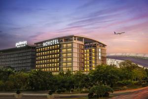 花都Novotel Guangzhou Baiyun Airport的飞机飞过头顶的酒店 ⁇ 染