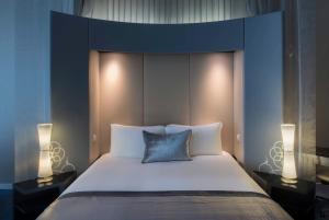 多哈W Doha的一间卧室配有一张大床和两盏灯