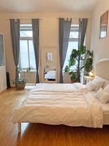 莱茵河畔路德维希港Mediterrane EG-Wohnung / BASF-Nähe / 650mbit WLAN的卧室设有一张大白色的床铺,设有窗户