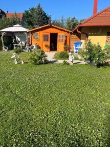 下厄尔什Rege apartman的一座带草地的庭院中的橙色房子