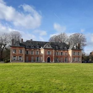 HeuquevilleChâteau de Heuqueville的一座大型砖砌建筑,拥有大片草地