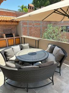 圣米格尔-德阿连德Doña Jose Suite & Apartments的天井配有桌子、椅子和沙发