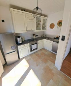 滨湖席弗灵Ferienwohnung Lucia的厨房配有白色橱柜和不锈钢用具