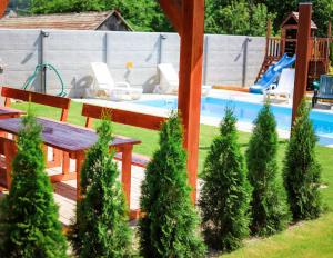 波达雅斯卡Rezidencia Podhájska的后院设有木凳和游泳池