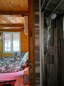 贝尔格莱德Kuca i splav na reci Savi的木屋内的卧室配有一张床