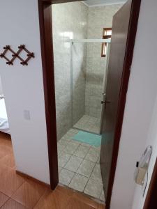 因比图巴POUSADA DA PONTE IBIRAQUERA的带淋浴的浴室和玻璃门