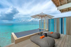 南马累环礁Hard Rock Hotel Maldives的甲板上的小型游泳池,享有海景