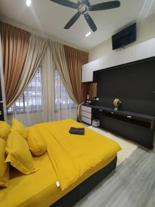 巴西古当Homestay 4BR with Outdoor Pool的卧室内的一张黄色大床,配有吊扇