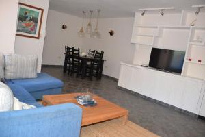 圣克鲁斯-德特内里费Beachfront Apartment - Tacoronte的客厅配有蓝色的沙发和茶几