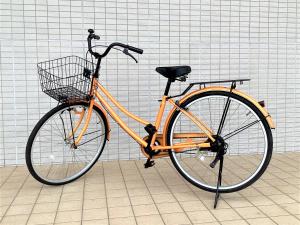 常滑市临空J酒店的一辆橘子自行车,装有篮子停在一个房间里