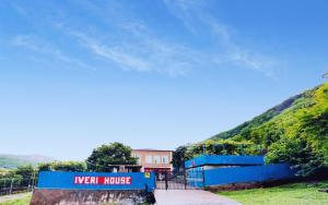 库塔伊西Iveri House的一座蓝色的建筑,上面有读新房子的标志