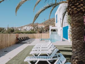 圣何塞Hostal Las Gaviotas del Cabo的一排棕榈树旁边的白色躺椅
