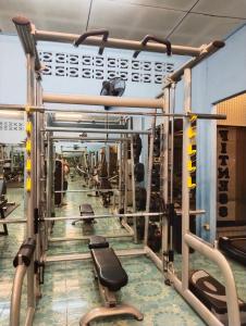 班拉克海滩SK Hometel Samui Airport的健身房,设有一排设备和举重器材