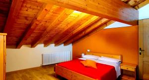 VelesoRistorante Bellavista con Locanda的木制天花板的红色床铺