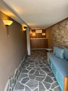 吉诺卡斯特Palorto Hotel的带沙发和砖墙的客厅