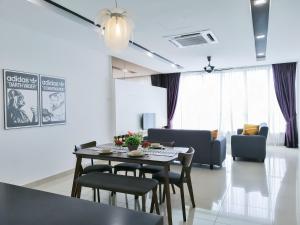吉隆坡Setapak Central Signature Suites by Manhattan Group的用餐室以及带桌椅的起居室。