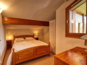 莫里永Appartement Morillon 1100, 4 pièces, 8 personnes - FR-1-642-65的一间卧室设有一张木床和一个窗户。