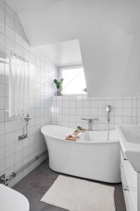 斯德哥尔摩Amazing family home in Stockholm的白色的浴室设有浴缸和水槽。
