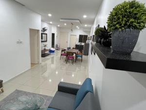 太平Home Away From Home In Taiping - Newly Upgraded!的客厅,配有桌子和台面上的植物
