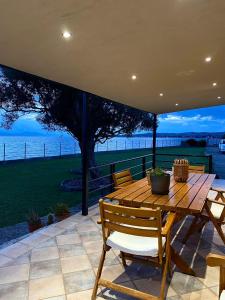 SkálaLuxury Beach Villa的海景庭院设有一张木桌和椅子。