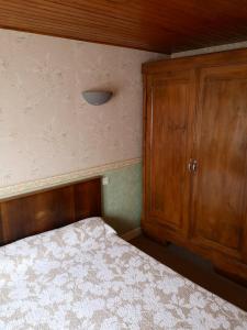 VergezacMaison de 2 chambres avec terrasse amenagee a Vergezac的一间卧室配有一张床和一个木制橱柜