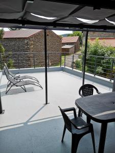 VergezacMaison de 2 chambres avec terrasse amenagee a Vergezac的庭院配有桌椅和遮阳伞。