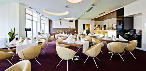 科沃布热格Apartament w Diva Spa 250m do plaży的餐厅设有白色的桌子和黄色的椅子