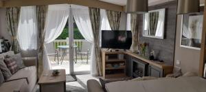 爱丁堡Luxury spacious family caravan的带沙发和电视的客厅