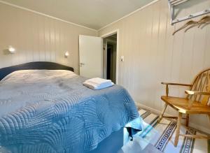 莱克内斯Cozy apartment Leknes Lofoten的一间卧室配有蓝色的床和椅子