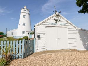 斯伯丁The Sir Peter Scott Lighthouse的一座建筑,后面有一座灯塔