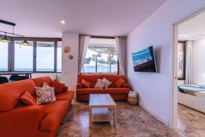 大加那利岛拉斯帕尔马斯1linea Canteras的客厅配有沙发和桌子