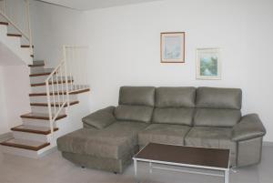 莱斯卡拉Casas La Vinya I的带沙发和楼梯的客厅