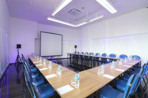 雅加达Moritz Biz Gandaria的一间会议室,配有长桌子和蓝色椅子
