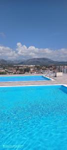 霍斯皮塔勒·德尔英福Apartamento con vista en L'Hospitalet del Infant的一个蓝色的大型游泳池,以城市为背景