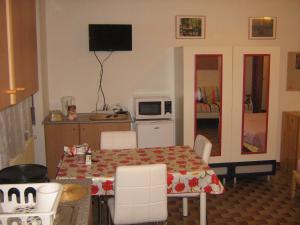 米兰Flat in Milan 3的一间带桌子的房间和一间带微波炉的厨房