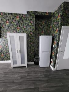 莱斯特City Centre Studios 3的客房设有2台冰箱和鲜花墙