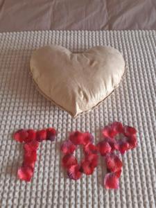 RuminghemBulles d'un soir Gite SPA的床上的心形面团和红色鲜花