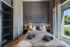 劳特阿赫KODA LOFT EXTENDED - Urlaub im Tiny House Bodensee的一间卧室设有一张大床和大窗户