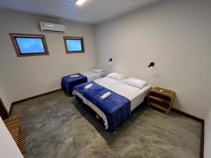 新艾朗Local Hostel Novo Airão的一间卧室设有两张床和两个窗户。