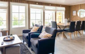 努尔菲尤尔埃德Cozy Home In Nordfjordeid With Wifi的客厅配有椅子和桌子,设有窗户