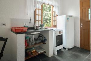 马利西亚斯Villa Salgada Maresias的厨房配有白色冰箱和水槽