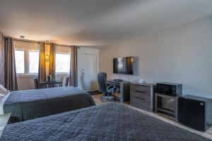 拉马巴耶Le 2020 Charlevoix的酒店客房设有两张床和一台平面电视。