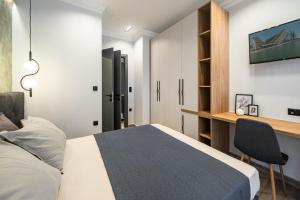 塞萨洛尼基ARES penthouse的一间卧室配有一张床和一张书桌