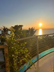 ChironguiSuite Villa au bord de la mer chez Saloua的日落时从阳台上欣赏到海景
