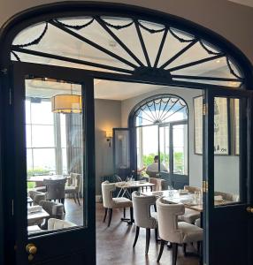 大莫尔文力推林中小屋酒店的一间带桌椅的用餐室和窗户。