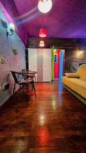 勒什Hostel Bermuda的客房设有一张桌子、一张床和紫色天花板。