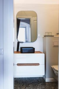 锡比乌Sia Boutique Aparthotel的一间带水槽和镜子的浴室