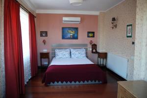雷贝里岛里索拉旅馆的一间卧室配有床和红色窗帘