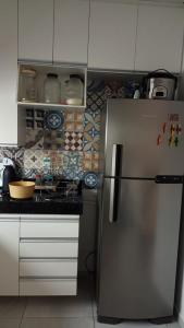 加拉尼温斯Casa Duplex - Garanhuns的厨房配有不锈钢冰箱和白色橱柜