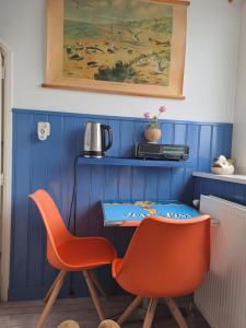 佐特兰德Unia's Verhuur的蓝色的客房配有2把椅子和桌子